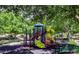 A shaded neighborhood playground with multiple slides, swings, and benches offers a fun recreation space for families at 1353 Volturno Way, Henderson, NV 89052