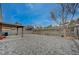 Large backyard with covered patio, interlocking brick pavers, and desert landscaping at 1404 Dragon Rock Dr, Henderson, NV 89052