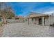 Backyard patio with interlocking brick pavers, covered patio, and mountain views at 1404 Dragon Rock Dr, Henderson, NV 89052