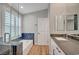 A sleek bathroom with a soaking tub, glass shower, and double vanity at 1404 Dragon Rock Dr, Henderson, NV 89052