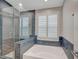 A luxurious bathroom with a glass shower and a soaking tub at 1404 Dragon Rock Dr, Henderson, NV 89052