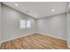 Bright and airy bedroom with wood-look floors and shuttered windows at 1404 Dragon Rock Dr, Henderson, NV 89052
