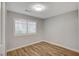 Cozy bedroom with wood flooring, neutral walls, and bright natural light at 1404 Dragon Rock Dr, Henderson, NV 89052