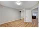 Bright bedroom with wood floors, mirrored closet, and open door to kitchen area at 1404 Dragon Rock Dr, Henderson, NV 89052