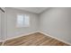 Cozy bedroom featuring wood flooring and bright natural light at 1404 Dragon Rock Dr, Henderson, NV 89052