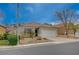 Charming single-story home featuring a two-car garage and desert landscaping at 1404 Dragon Rock Dr, Henderson, NV 89052