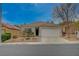 Charming single-story home featuring a well-maintained front yard and a two-car garage at 1404 Dragon Rock Dr, Henderson, NV 89052
