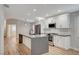 Bright kitchen featuring white cabinets, an island, and stainless steel appliances at 1404 Dragon Rock Dr, Henderson, NV 89052