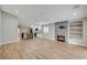 Open-concept living room with wood floors, fireplace, and modern kitchen with island at 1404 Dragon Rock Dr, Henderson, NV 89052
