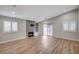 Bright living room featuring a fireplace, wood-look floors, and plantation shutters at 1404 Dragon Rock Dr, Henderson, NV 89052