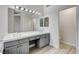 Bathroom featuring a double vanity sink, modern fixtures, and a bright window at 1700 Wandering Winds Way, Las Vegas, NV 89128