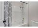 This bathroom features a tub with white tile surround and stylish grey shower curtain at 1700 Wandering Winds Way, Las Vegas, NV 89128
