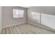 Neutral bedroom featuring wood-look flooring and window with blinds at 1700 Wandering Winds Way, Las Vegas, NV 89128
