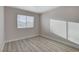 This bedroom features wood-look floors, bright natural light from the window, and neutral paint at 1700 Wandering Winds Way, Las Vegas, NV 89128