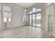 Bright bedroom with natural light, wood floors, and a sliding glass door to the outside at 1700 Wandering Winds Way, Las Vegas, NV 89128