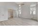 Bedroom featuring wood floors, ample natural light, and a closet with sliding mirror doors at 1700 Wandering Winds Way, Las Vegas, NV 89128