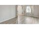 Bright, airy bedroom featuring neutral decor, modern laminate flooring, and a window with decorative curtains at 1700 Wandering Winds Way, Las Vegas, NV 89128