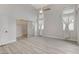 Bright bedroom features wood-style floors, a ceiling fan, and natural light at 1700 Wandering Winds Way, Las Vegas, NV 89128