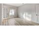 Bright bedroom with wood-look floors and French doors opening to a light-filled room at 1700 Wandering Winds Way, Las Vegas, NV 89128