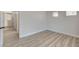 Bright bedroom featuring light wood-look floors, neutral paint, and a hallway at 1700 Wandering Winds Way, Las Vegas, NV 89128