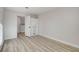 Empty bedroom showcasing wood-look flooring and closet at 1700 Wandering Winds Way, Las Vegas, NV 89128