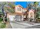 Charming two-story home with a well-maintained yard and a two-car garage at 1700 Wandering Winds Way, Las Vegas, NV 89128