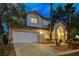Charming two-story home with mature landscaping, tile roof, and attached two-car garage at 1700 Wandering Winds Way, Las Vegas, NV 89128