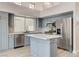 Modern kitchen with gray cabinets, a center island, stainless steel appliances, and lots of light at 1700 Wandering Winds Way, Las Vegas, NV 89128