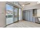View of the kitchen area with gray cabinets and pool access at 1700 Wandering Winds Way, Las Vegas, NV 89128