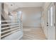 Bright living space with modern chandelier, wood-look floors, and stairs to the second floor at 1700 Wandering Winds Way, Las Vegas, NV 89128