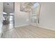 Spacious living room featuring light wood floors, modern chandelier, and neutral paint at 1700 Wandering Winds Way, Las Vegas, NV 89128