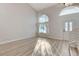 Bright living room featuring light wood floors, large windows, and a vaulted ceiling at 1700 Wandering Winds Way, Las Vegas, NV 89128