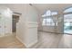 Open living room with light wood floors, a sliding glass door and large windows for ample light at 1700 Wandering Winds Way, Las Vegas, NV 89128