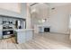 Open-concept layout with a fireplace, kitchen view, and light wood flooring at 1700 Wandering Winds Way, Las Vegas, NV 89128