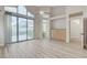 Bright bedroom with sliding glass doors, modern lighting, and en-suite bathroom at 1700 Wandering Winds Way, Las Vegas, NV 89128