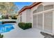 Gorgeous backyard pool with surrounding patio and lush landscaping offers serene outdoor living at 1700 Wandering Winds Way, Las Vegas, NV 89128