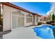 Backyard features a sparkling pool with easy access from the home's screened sliding doors at 1700 Wandering Winds Way, Las Vegas, NV 89128