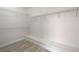 Bright walk-in closet features built-in shelving and laminate floors; ideal for organized storage at 1700 Wandering Winds Way, Las Vegas, NV 89128