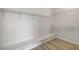Spacious walk-in closet with built-in shelving and a clean, well-lit interior with laminate floors at 1700 Wandering Winds Way, Las Vegas, NV 89128