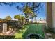 Beautiful backyard featuring artificial grass, mature trees, and a playful tire swing, perfect for Gathering fun at 182 Cantamar St, Henderson, NV 89074