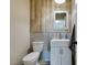 Modern powder room with a wood accent wall and stylish fixtures at 182 Cantamar St, Henderson, NV 89074