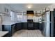 Bright kitchen with stainless steel appliances, black cabinetry, and modern backsplash at 182 Cantamar St, Henderson, NV 89074