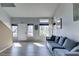 Bright living room showcasing large windows, modern flooring, and comfortable gray couch at 182 Cantamar St, Henderson, NV 89074