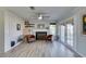 Bright living room with a fireplace, ceiling fan, and French doors that lead to the backyard at 182 Cantamar St, Henderson, NV 89074