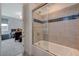 Stylish bathroom with a shower over tub featuring decorative tile and a view into bedroom at 195 Cactus Sunrise St, Las Vegas, NV 89138