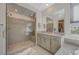 Bathroom with large tiled shower, vanity, and lots of natural light at 195 Cactus Sunrise St, Las Vegas, NV 89138