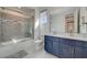 Elegant bathroom with dual sinks, a modern shower-tub combination, and contemporary fixtures at 195 Cactus Sunrise St, Las Vegas, NV 89138