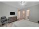 Spacious bedroom with a television, comfortable chair, and a luxurious Primary bathroom nearby at 195 Cactus Sunrise St, Las Vegas, NV 89138