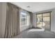 Bedroom with large windows, curtains, and sliding glass door leading to covered deck at 195 Cactus Sunrise St, Las Vegas, NV 89138