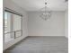 Dining room with a modern chandelier, tile floors, and a large window at 195 Cactus Sunrise St, Las Vegas, NV 89138